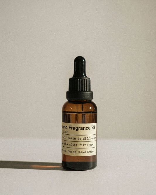 Vintage amber glass bottle of Charabanc Fragrance 29 Santal Manuscript, featuring a minimalist apothecary label.